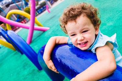 High angle portrait of boy relaxing in swimming pool