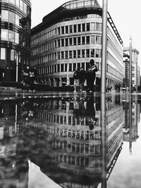 Reflection of buildings on puddle in city