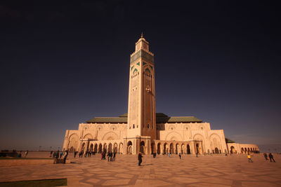 Low angle view of mosque hassan ii against clear sky in city