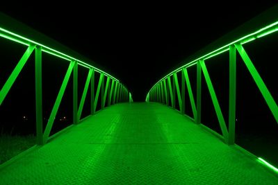 Illuminated tunnel at night