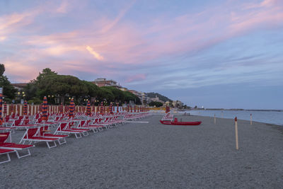 Scenic view of beach against sky at sunset