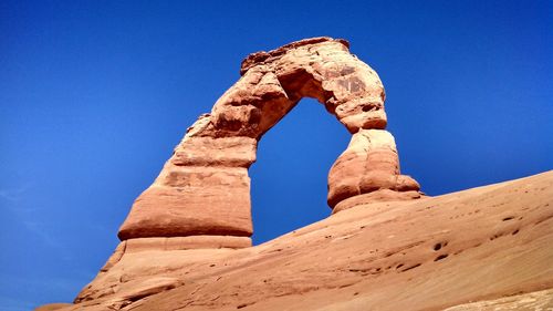 Low angle view of old ruins against clear blue sky