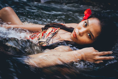 Portrait of man lying in water