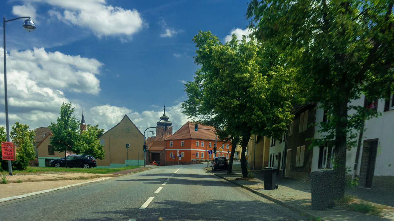 STREET BY HOUSES AGAINST SKY