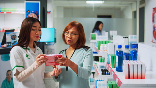 Portrait of female friends in laboratory