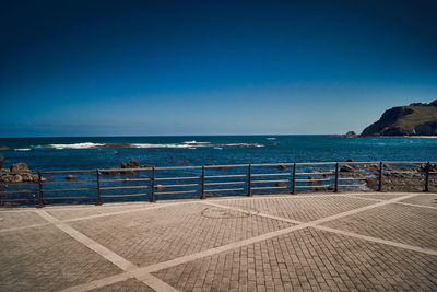 Scenic view of sea against clear blue sky