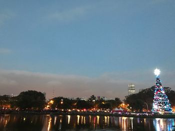 Illuminated buildings in city at waterfront