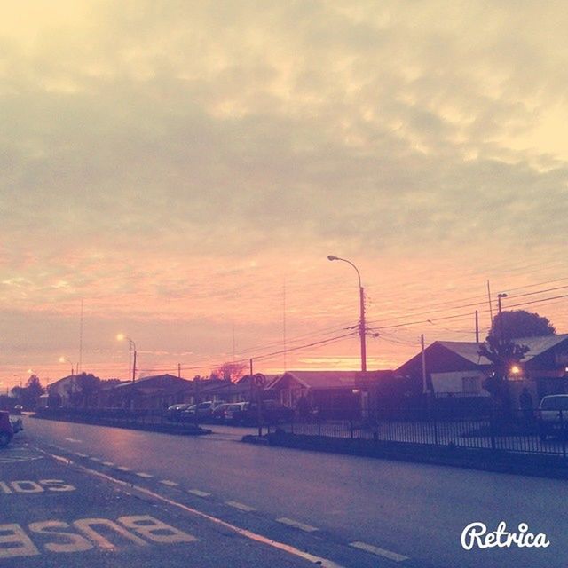 road, transportation, sky, road marking, sunset, cloud - sky, street light, the way forward, communication, street, road sign, car, cloudy, arrow symbol, cloud, guidance, outdoors, text, dusk, information sign