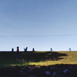 People on field against sky