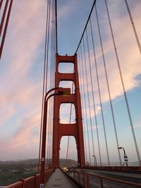 View of suspension bridge against cloudy sky