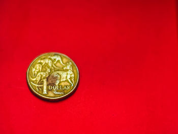 Close-up of coin on red background