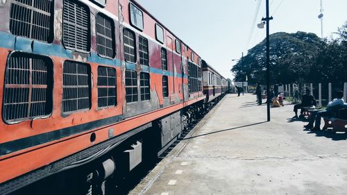 Train on railroad tracks in city against sky