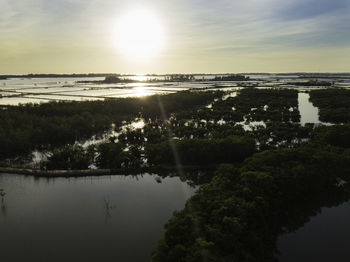 Scenic view of lake against sky during sunset