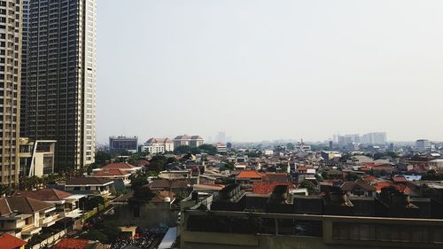 Buildings in city against clear sky