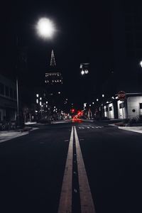 Illuminated road in city at night