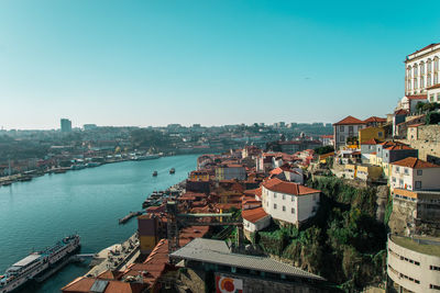 High angle view of boats moored on douro river by buildings against sky