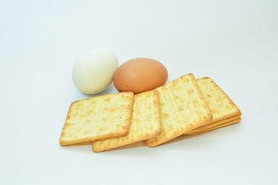 Close-up of eggs against white background