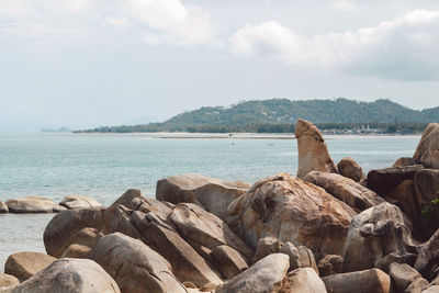 Rocks on sea shore against sky