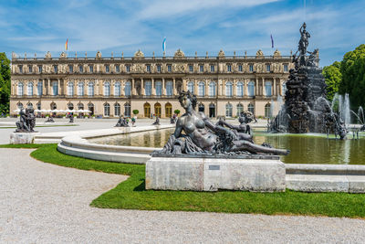 Fountain and castle against sky