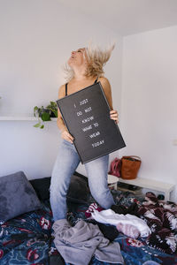 Young woman lying on bed at home