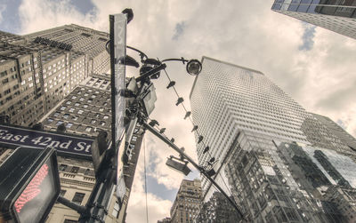 Low angle view of buildings against cloudy sky