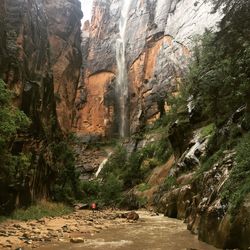 Scenic view of waterfall on rocky mountains