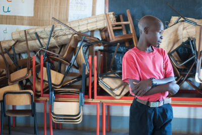 Rear view of boy looking at camera