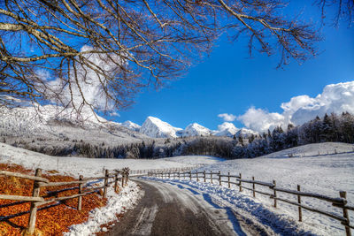 Snow covered landscape against sky