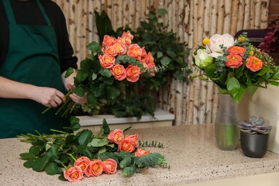 Florist arranging a bouquet of roses