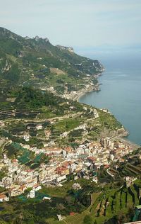 High angle view of sea and mountains against sky