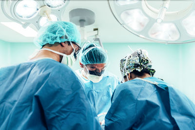 Surgeons performing surgery in operating room