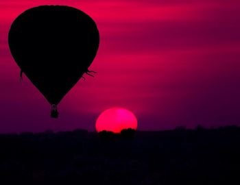 Hot air balloons on landscape at sunset