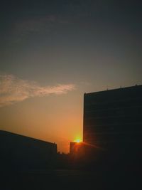 Low angle view of building against sky at sunset