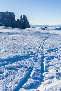 Scenic view of snow covered land against sky