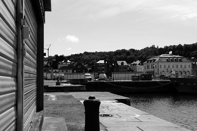 Boats moored in harbor against buildings in city