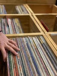 Cropped hand of person touching files in drawer