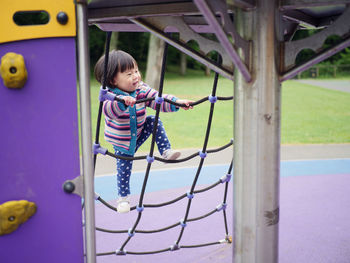 Side view of boy playing at playground