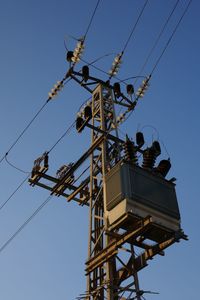 Low angle view of telephone pole against clear sky