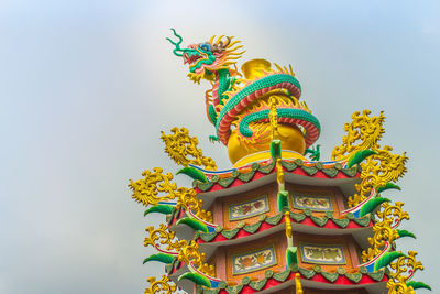 Low angle view of statue against sky