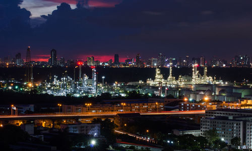 High angle view of illuminated city against sky at night