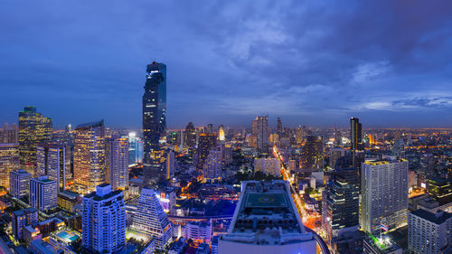 Illuminated cityscape against sky at night