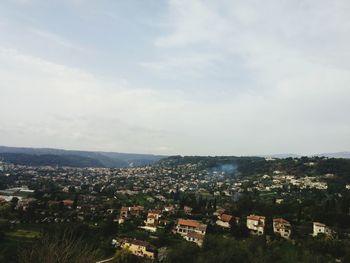 High angle view of houses in town against sky