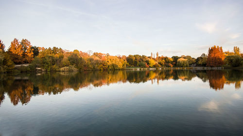 Reflection of trees in lake against sky during sunset