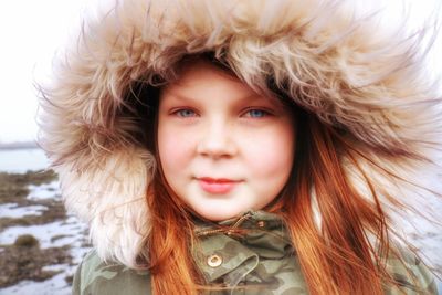 Portrait of cute girl wearing fur coat during winter