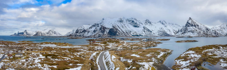 Scenic view of snowcapped mountains by lake against sky