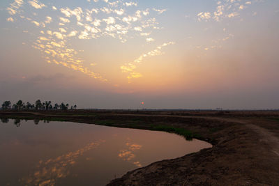 Scenic view of lake against sky during sunset