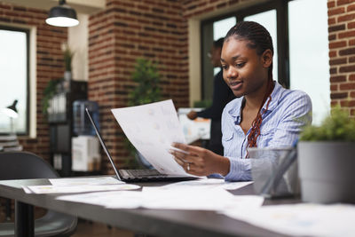 Businesswoman reading document in office