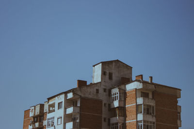 Low angle view of buildings against clear blue sky