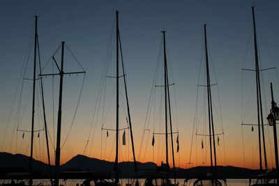 Low angle view of silhouette sailboats against sky at sunset