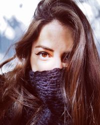 Close-up portrait of woman in winter